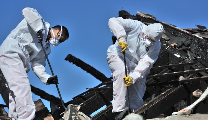 Professional worker restoring a fire damaged area