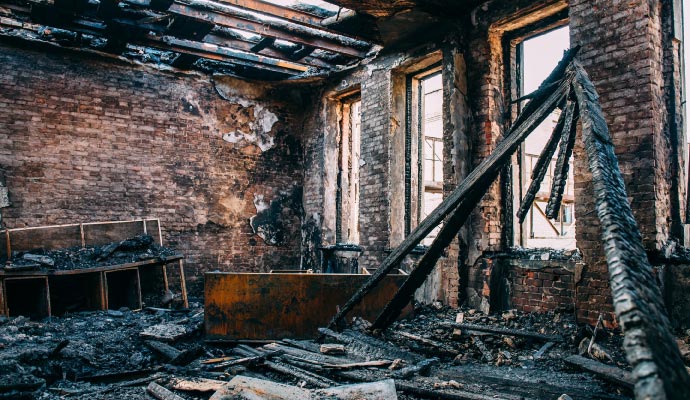 An interior of a room severely damaged by fire