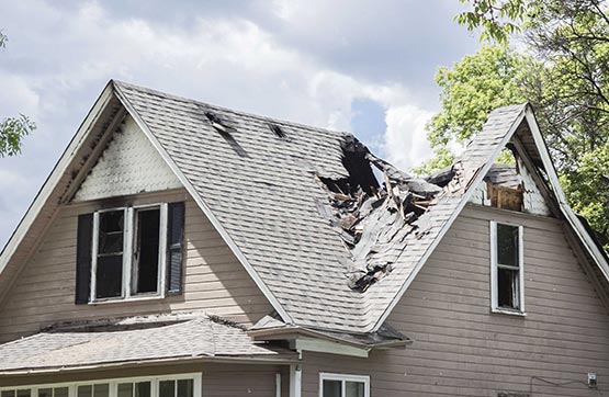 gray shingle house roof storm damage