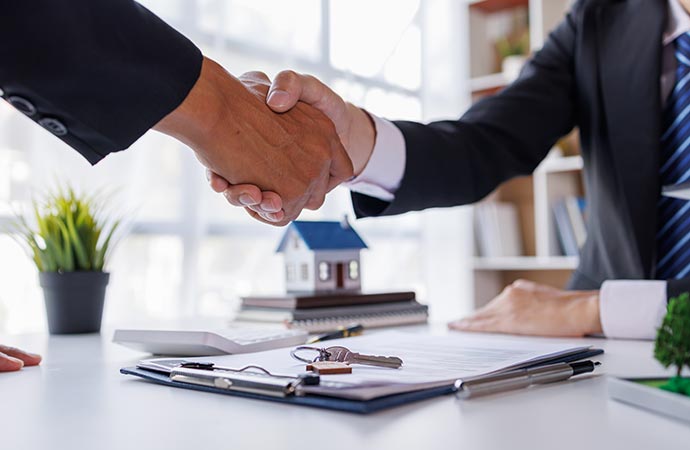 handshake real estate agent and customer agreemen fire insurance claim