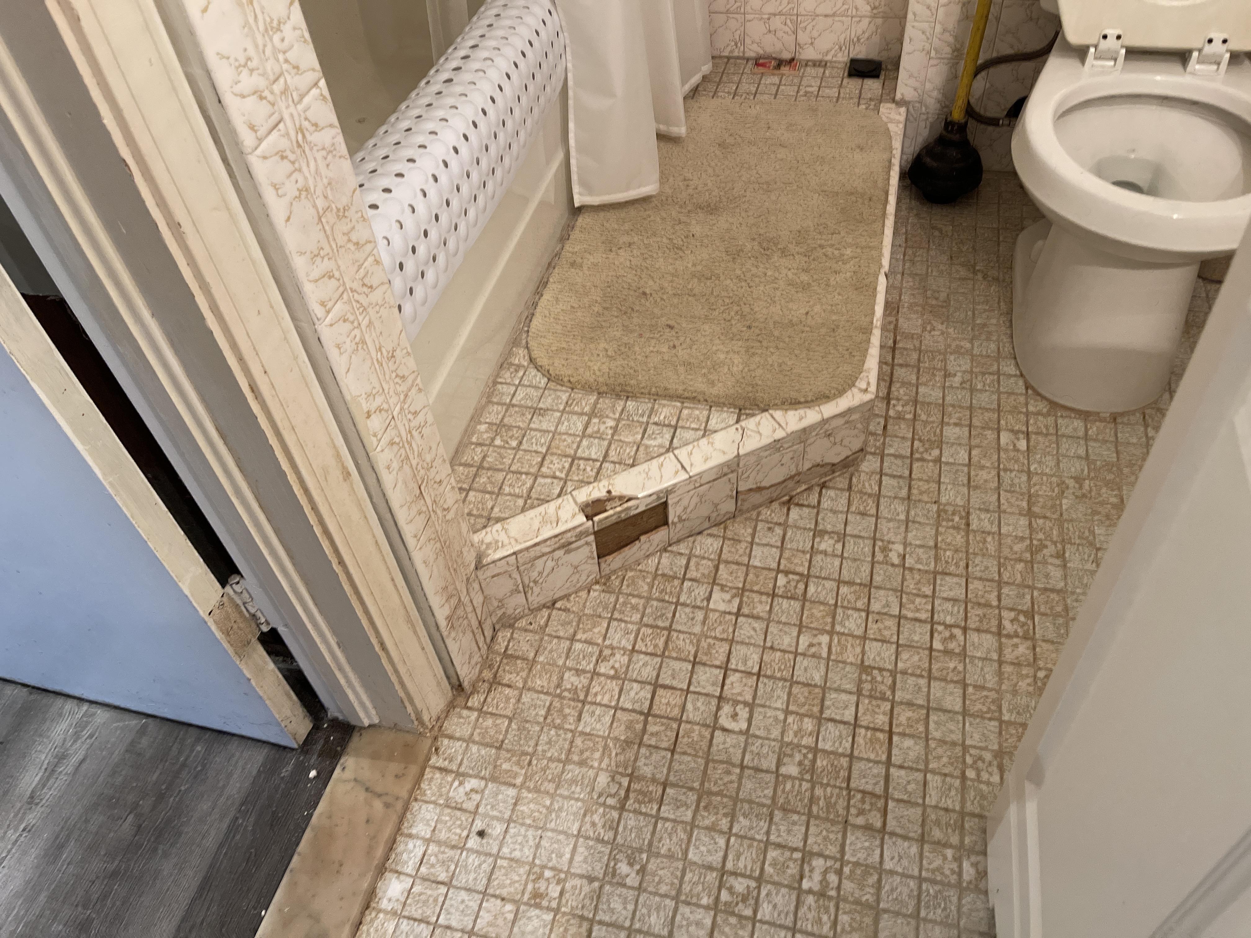 Tiles and flooring damaged from the plumbing leak