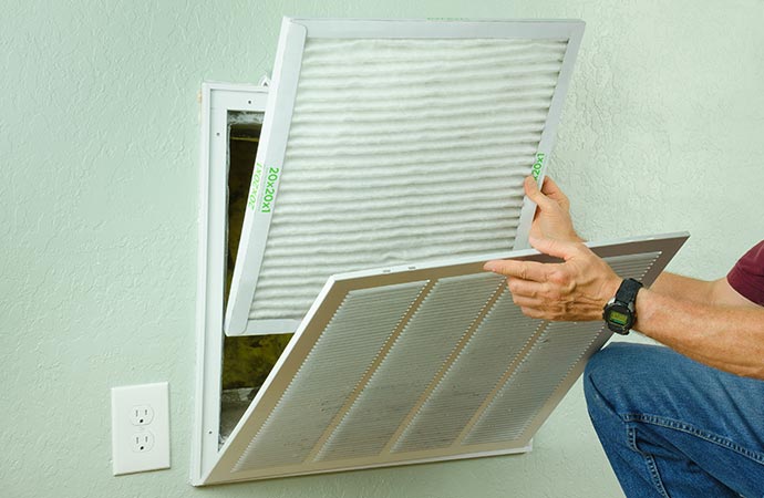 Professional worker replacing air filter