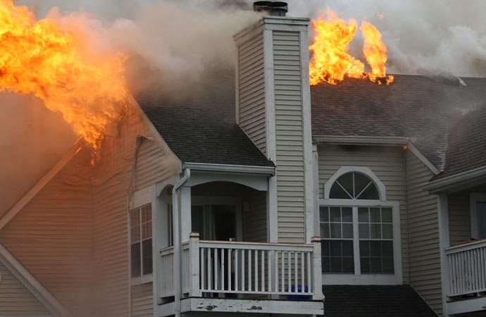 residential house rooftop burning with fire insurance claim