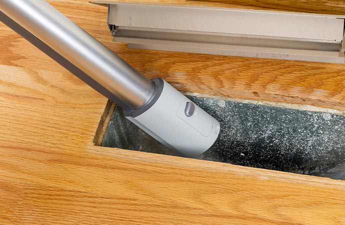 Inside floor vent vacuum cleaning