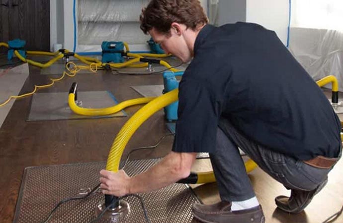 Worker providing immediate assistance during water damage 