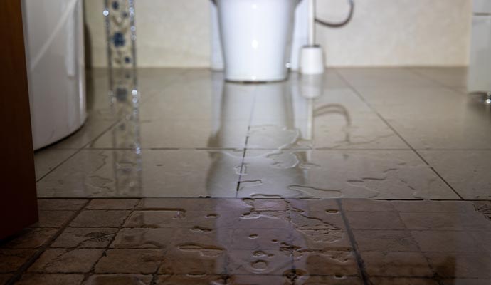 water damage puddle on bathroom floor