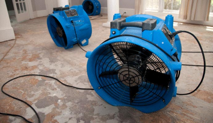 Water damage restoration with professional equipment